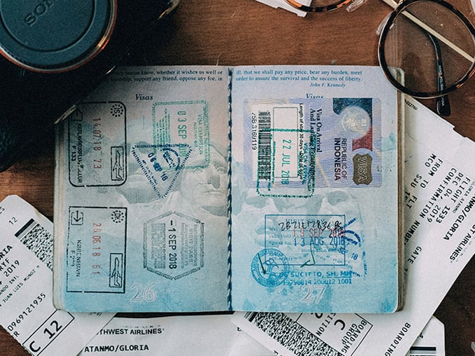 Passport and travel papers laid out on a table, symbolizing the practical steps missionaries take as the church prays for those being sent.